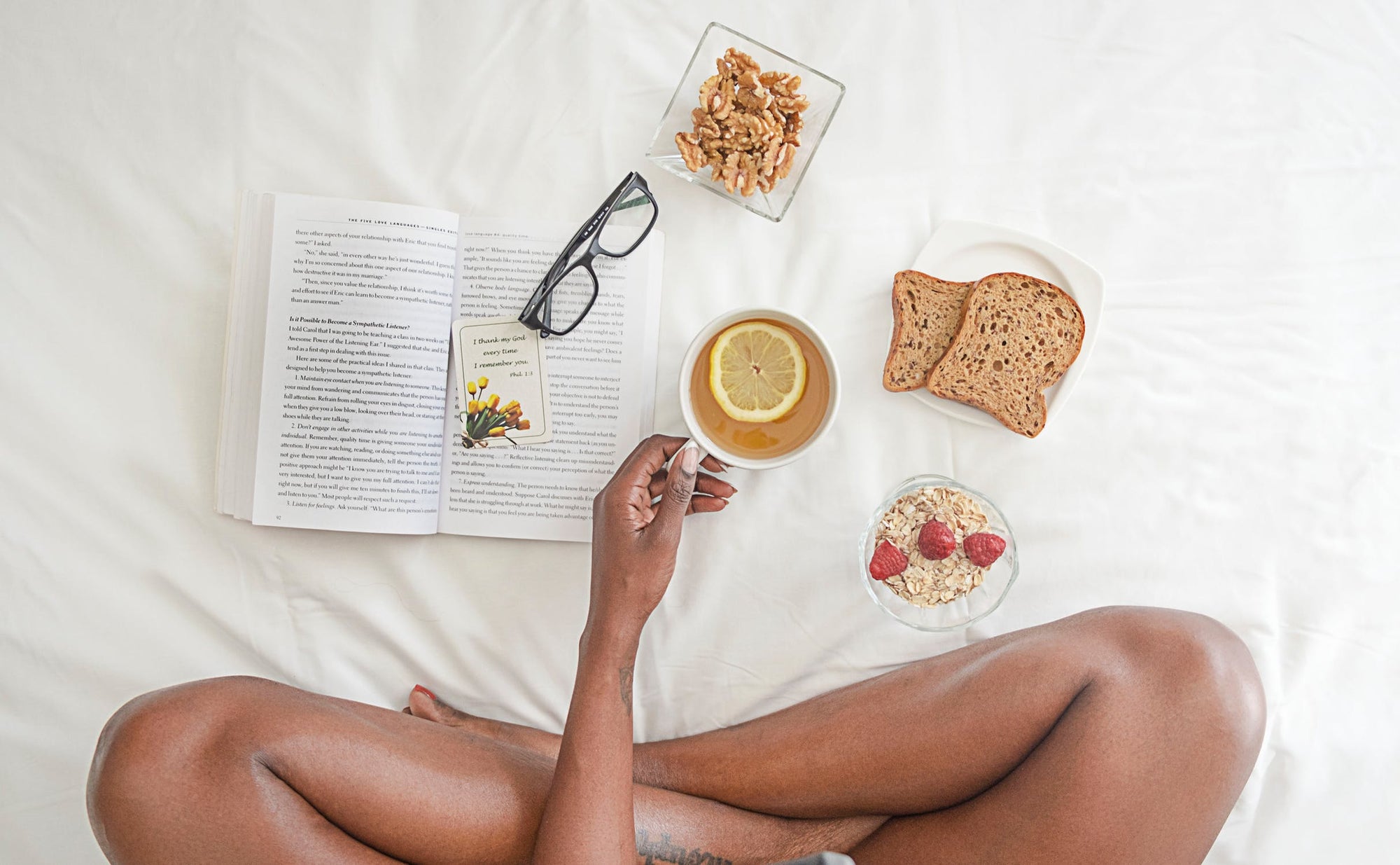Woman researching organic sex lube while eating breakfast on her bed